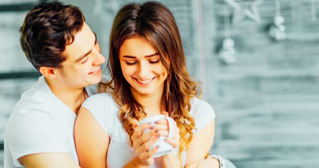 Partners holding hands and smiling, representing trust and lasting love”